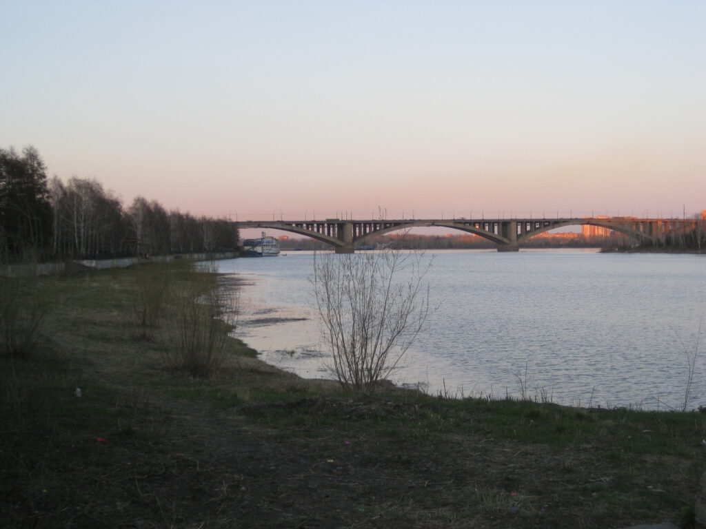 Kommunale Brücke über Jenissei in Krasnojarsk bei Sonnenuntergang. 
