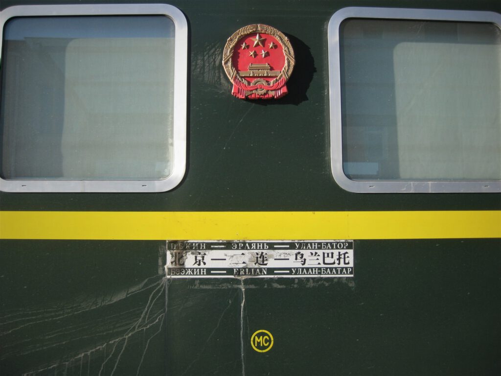 Nachtzug nach China. Grüner Zug der chinesischen Eisenbahn mit Wappen und dreisprachiger Anzeige. Peking – Erlian – Ulan Bator. 