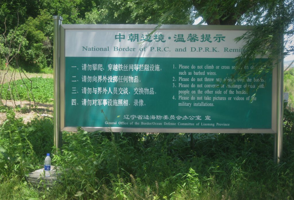 Schild an der Grenze zwischen China und Nordkorea am Tigerberg. Anweisungen an Touristen.