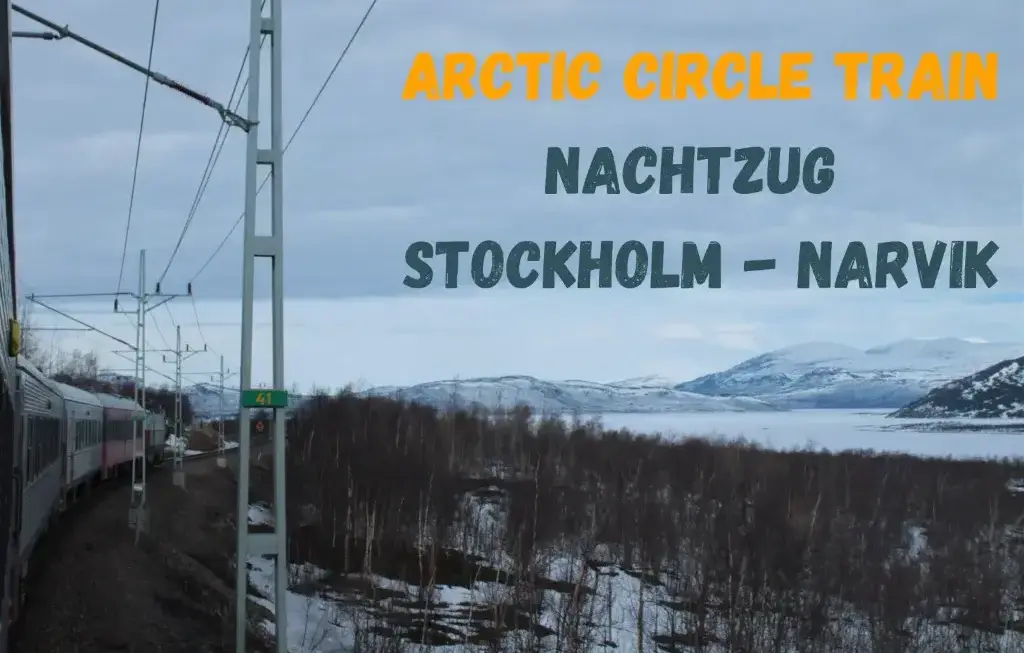 Arctic Circle Train - Blick in die verschneite Fjordlandschaft. Links der abbiegende Zug nach Narvik.