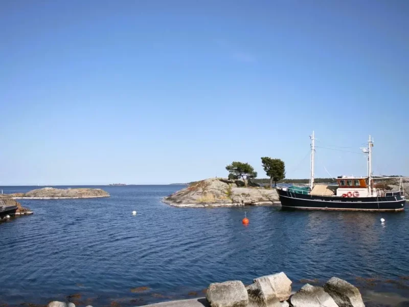 Stockholmer Schärengarten. Boot vor der Küste von Möja, am Hafen Ramsmora. Blauer Himmel.